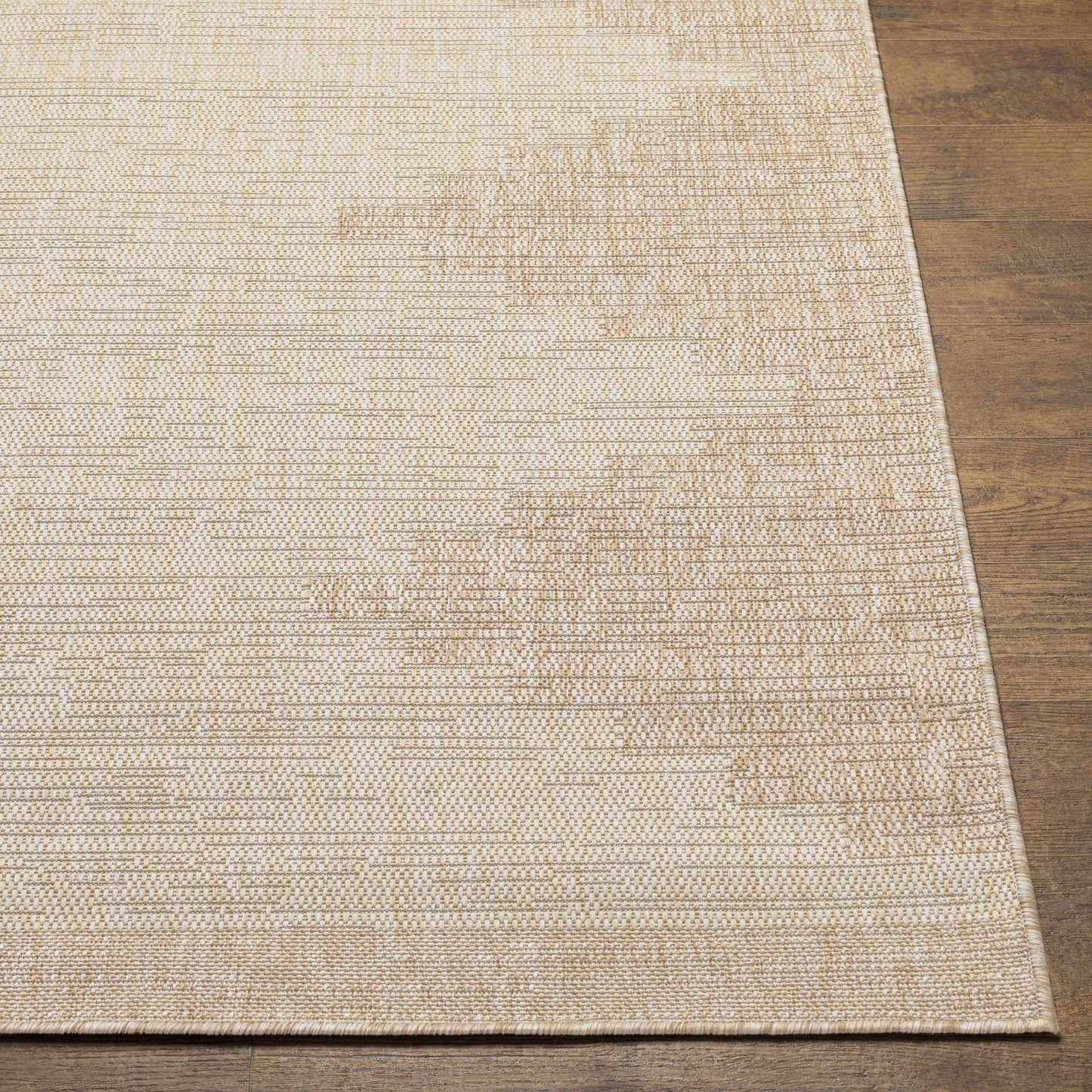 Beige woven rug on a wooden floor