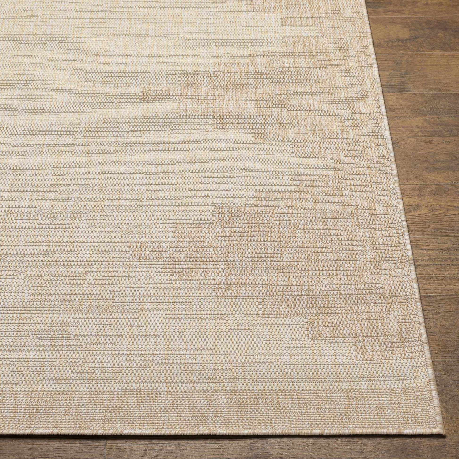 Beige woven rug on a wooden floor