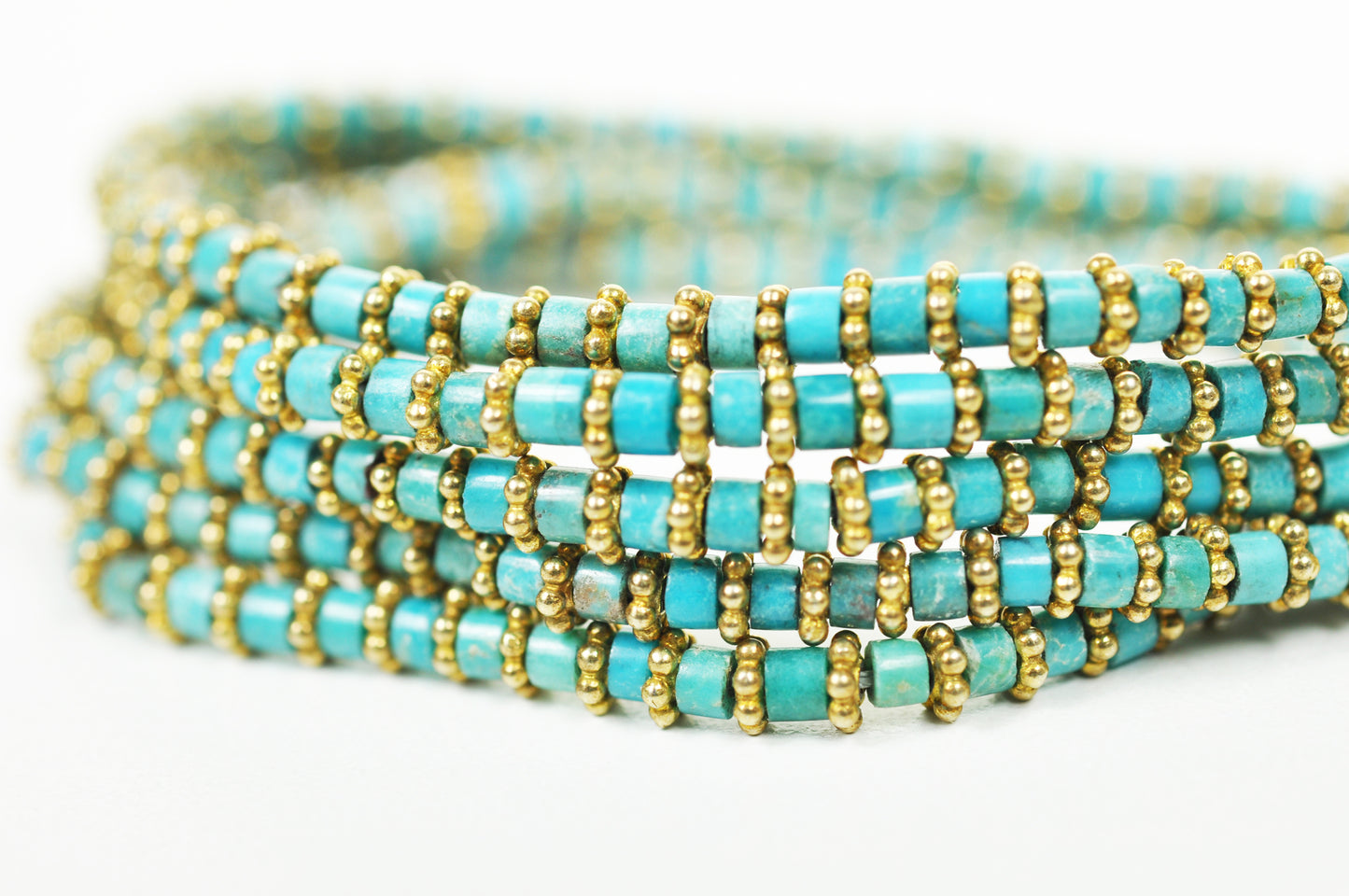 Close-up of turquoise beads and gold-plated brass detailing