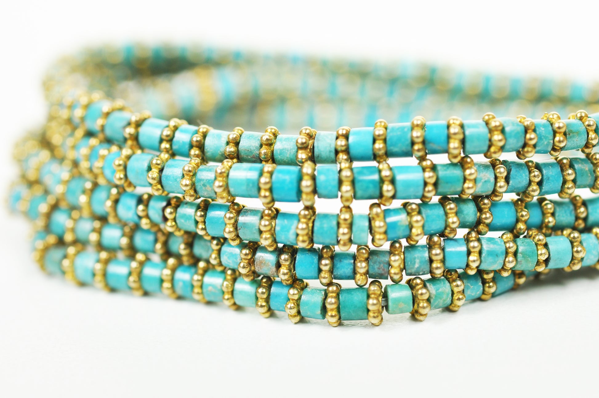Close-up of turquoise beads and gold-plated brass detailing