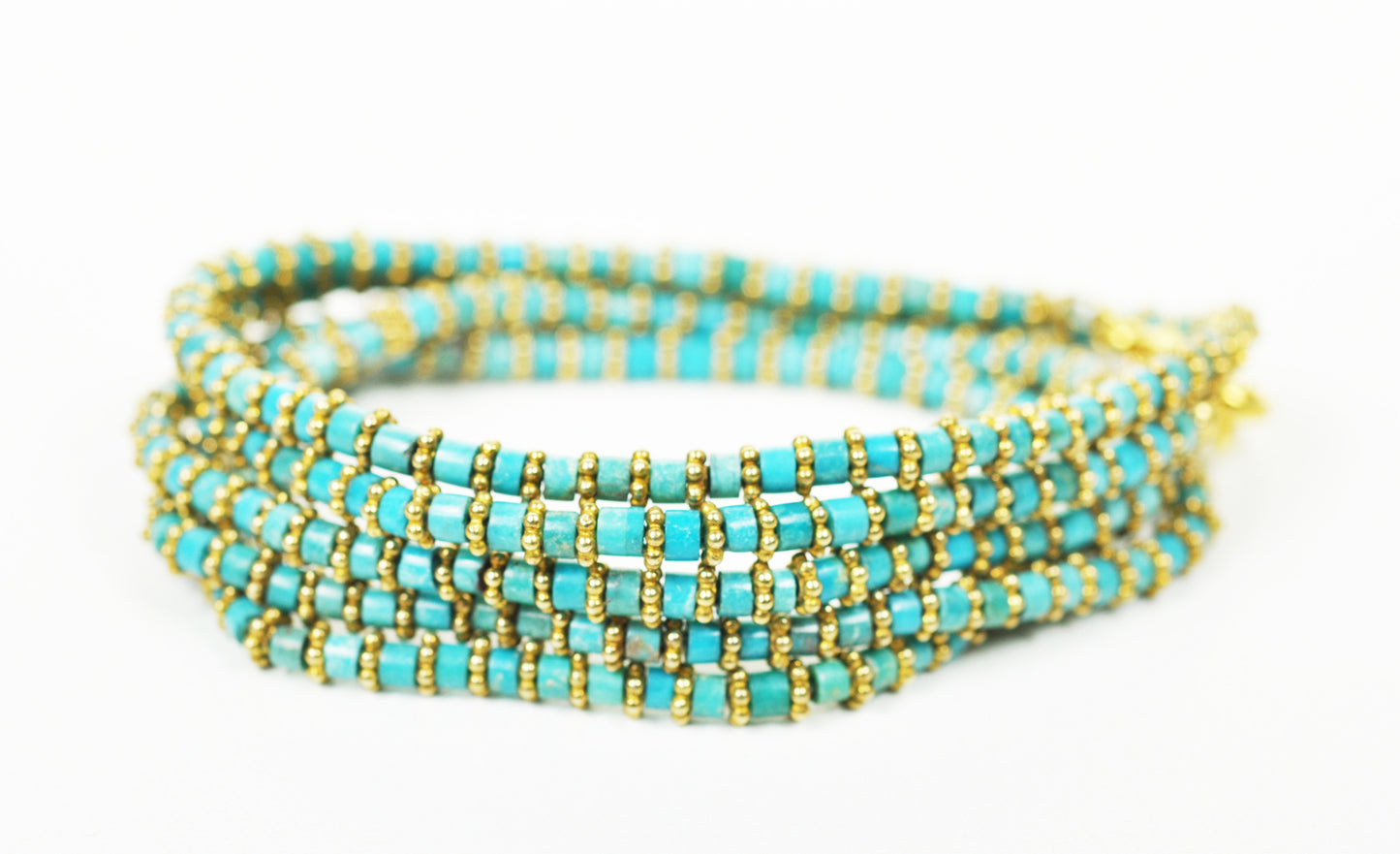 Stacked view of turquoise wrap bracelet with gold accents