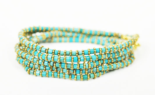Stacked view of turquoise wrap bracelet with gold accents